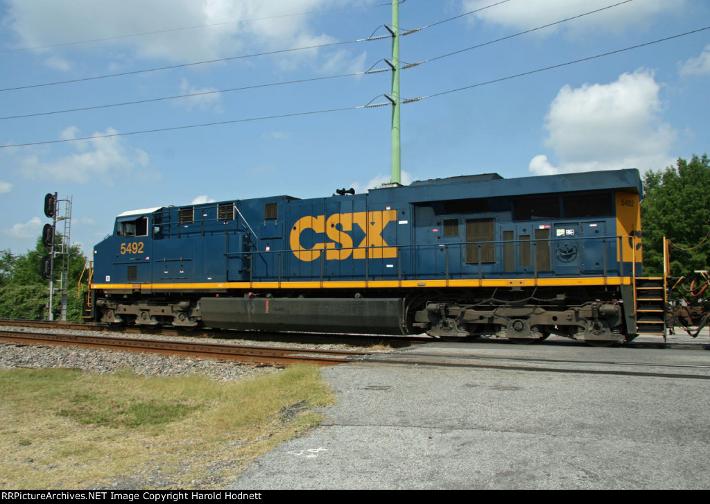 CSX 5492 leads train Q491 across Evans Street after leaving the yard